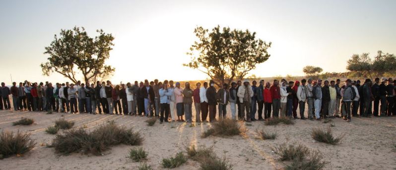 a queue of people in the desert